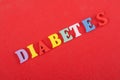 DIABETETES word on red background composed from colorful abc alphabet block wooden letters, copy space for ad text. Learning Royalty Free Stock Photo