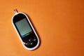 A diabetic checks his blood sugar. Close up man hands self-tested with a Lancet and a glucometer at home