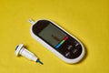 A diabetic checks his blood sugar. Close up man hands self-tested with a Lancet and a glucometer at home