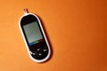 A diabetic checks his blood sugar. Close up man hands self-tested with a Lancet and a glucometer at home