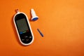 A diabetic checks his blood sugar. Close up man hands self-tested with a Lancet and a glucometer at home