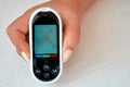 A diabetic checks his blood sugar. The woman is self-tested with a Lancet and a glucometer at home. Negative result