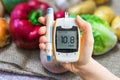 Diabetic diet and diabetes concept. Hand holds glucometer. Royalty Free Stock Photo