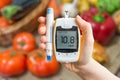 Diabetic diet and healthy eating concept. Glucometer and vegetables.