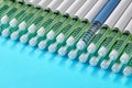 Diabetic insulin pens lined up on a blue background. One blue syringe in a row of many gray syringes Royalty Free Stock Photo