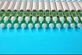 Diabetic insulin pens lined up on a blue background