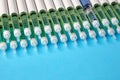 Diabetic insulin pens lined up on a blue background