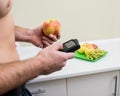 Diabetic man with an insulin pump connected in his abdomen. Royalty Free Stock Photo