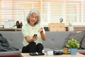 Diabetic mature woman measuring blood glucose with glucose meter at home. Diabetes and Elderly health are concept