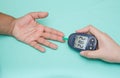 Diabetic patient measuring glucose with glucometer