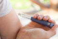 A diabetic patient using insulin pen for making an insulin injection at home. Young man control sugar diabetes. Diabetic lifestyle Royalty Free Stock Photo