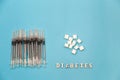 Diabetic printed letters, insulin syringes and sugar pile Royalty Free Stock Photo