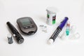 Diabetic set of lancet with spare needles, glucometer, strips, box of spare strips, pen injector, spare insulin and pen needles Royalty Free Stock Photo