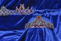 Diadem with green stones on a blue velvet background. Eastern tiara. Jewelry design