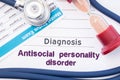 Diagnosis of Antisocial personality disorder ASPD. On psychiatrist or psychologist table is paper with inscription Antisocial pe