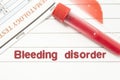Diagnosis Bleeding Disorder. Notepad with text labels Bleeding Disorder, laboratory test tubes for the blood, blood smear for micr