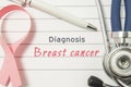 Diagnosis Breast Cancer. Pink ribbon as symbol of struggle with cancer and stethoscope lying on medical form with text labels Diag