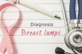 Diagnosis Breast Lumps. Pink ribbon as symbol of struggle with cancer and stethoscope lying on medical form with text labels Diagn