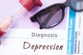 Diagnosis of Depression. Hourglass, doctor glasses, mental status exam are near inscription Depression. Causes, symptoms, diagnosi