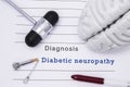 Diagnosis of Diabetic neuropathy. Neurological hammer and brain figure lie on a medical  paper form with a heading diagnosis of Di Royalty Free Stock Photo