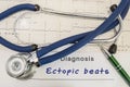 Diagnosis of Ectopic beats. Stethoscope and recorded electrocardiogram  on paper lying horizontally inscription diagnosis Ectopic Royalty Free Stock Photo