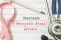 Diagnosis Fibrocystic breast disease. Pink ribbon as symbol of struggle with breast oncology and disorders and stethoscope lying o