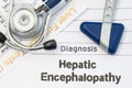 Diagnosis Hepatic Encephalopathy. Neurological hammer, stethoscope and liver laboratory test lie on note with title of Hepatic Enc