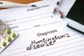 Diagnosis Huntingtons disease and tablets on a wooden table. Royalty Free Stock Photo
