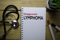 Diagnosis Lymphoma write on the book with wooden table background