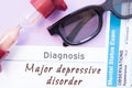 Diagnosis of Major Depressive Disorder. Hourglass, doctor glasses, mental status exam are near inscription Major Depressive Disord