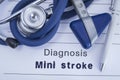 The diagnosis of mini stroke TIA. Paper medical history with diagnosis of mini stroke, on which lie stethoscope, neurological ha