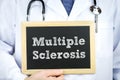 Diagnosis multiple sclerosis doctor holding chalkboard