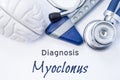 Diagnosis of Myoclonus. Anatomical brain figure, neurological hammer and stethoscope lying on sheet of paper or book with the titl