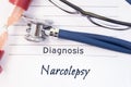 Diagnosis Narcolepsy. Psychiatric diagnosis Narcolepsy is written on paper, on which lay stethoscope and hourglass for measuring t Royalty Free Stock Photo