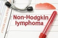 Diagnosis of Non-Hodgkin lymphoma. Laboratory blood bottle, glass slide with blood smear, hematology test, stethoscope lying on no Royalty Free Stock Photo