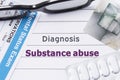 Diagnosis Substance Abuse. Medical notebook labeled Diagnosis Substance Abuse, psychiatric mental questionnaire and pills are on t Royalty Free Stock Photo