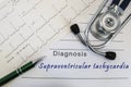 Diagnosis of Supraventricular tachycardia. Stethoscope, green pen and electrocardiogram lie on medical form with diagnosis of Supr