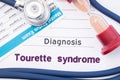 Diagnosis of Tourette syndrome. On psychiatrist or psychologist table is paper with inscription Tourette syndrome disease near p