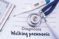 Diagnosis of walking pneumonia. Stethoscope, electronic thermometer, common blood test results are on medical form, which indicate Royalty Free Stock Photo