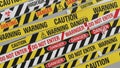 Diagonal array of warning and danger tapes with caution and do not enter labels Royalty Free Stock Photo