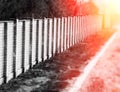 Diagonal brick fence with light leak background