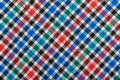 Diagonal Checkered plaid fabric background. Texture of red blue green plaid fabric Royalty Free Stock Photo