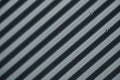 Diagonal close-up of striped ribbed metal surface