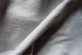Diagonal fold on simple gray jersey fabric