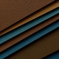 Diagonal layers of textured paper in earthy brown and muted teal shades create a