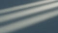 Diagonal light beams casting soft shadows on a textured blue gray wall Royalty Free Stock Photo