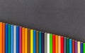 Line of colored pencils bottom side dark background top view Royalty Free Stock Photo