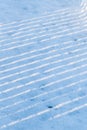 Diagonal lines of light in snow, shadows in snow Royalty Free Stock Photo