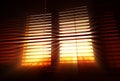 Diagonal office blinds with dramatic rays background