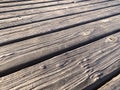 Diagonal pier wood boards wooden boat dock fishing board boardwalk walkway old vintage sea deck Royalty Free Stock Photo